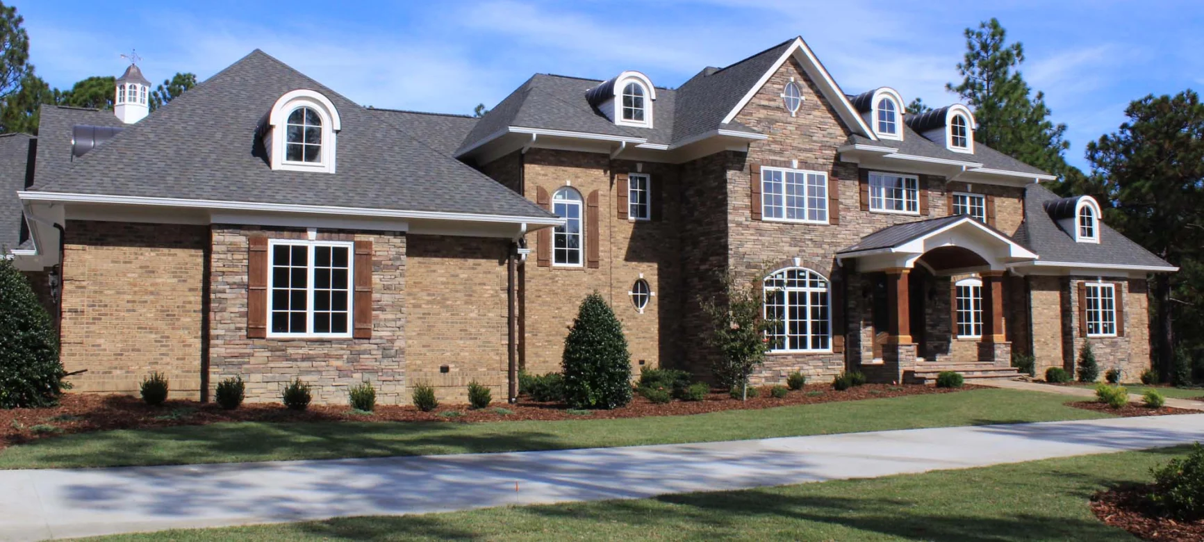 Pinehurst Home with Asphalt Roof & Metal Dormers